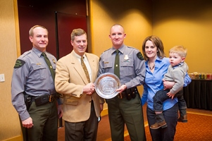 Michigan CO Joel Lundberg (center) with DNR law enforcement staff and his wife and son