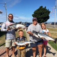 Family holding up catch from charter trip
