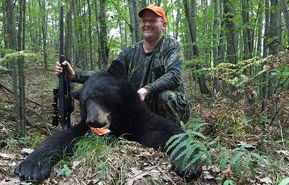 hunter with bear that he took