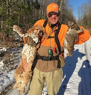 hunter with grouse and dog