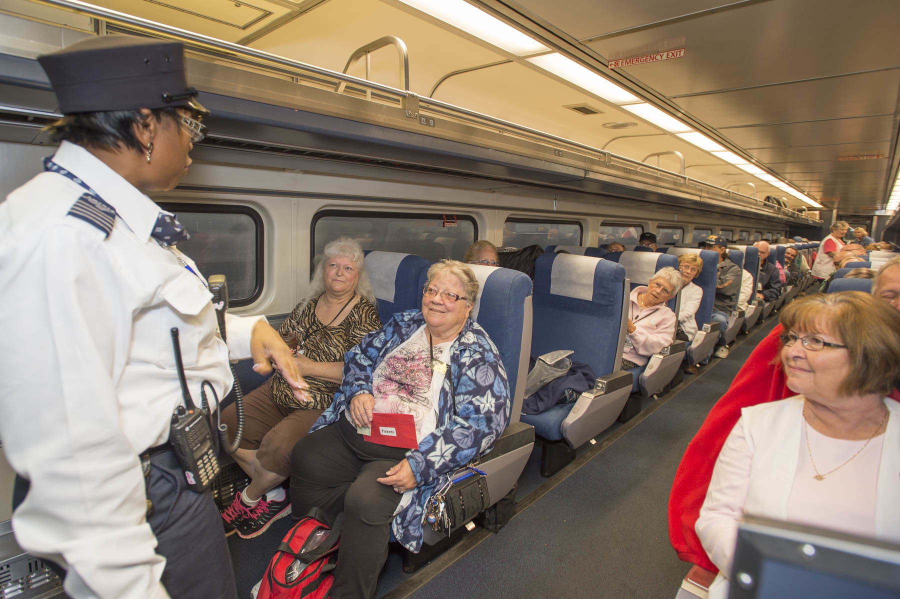 Amtrak conductor talks to passenger on the Blue Water
