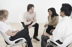 Dislocated workers in small group meeting