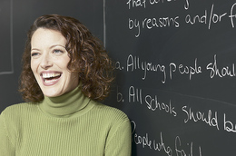 Smiling woman in front of blackboard