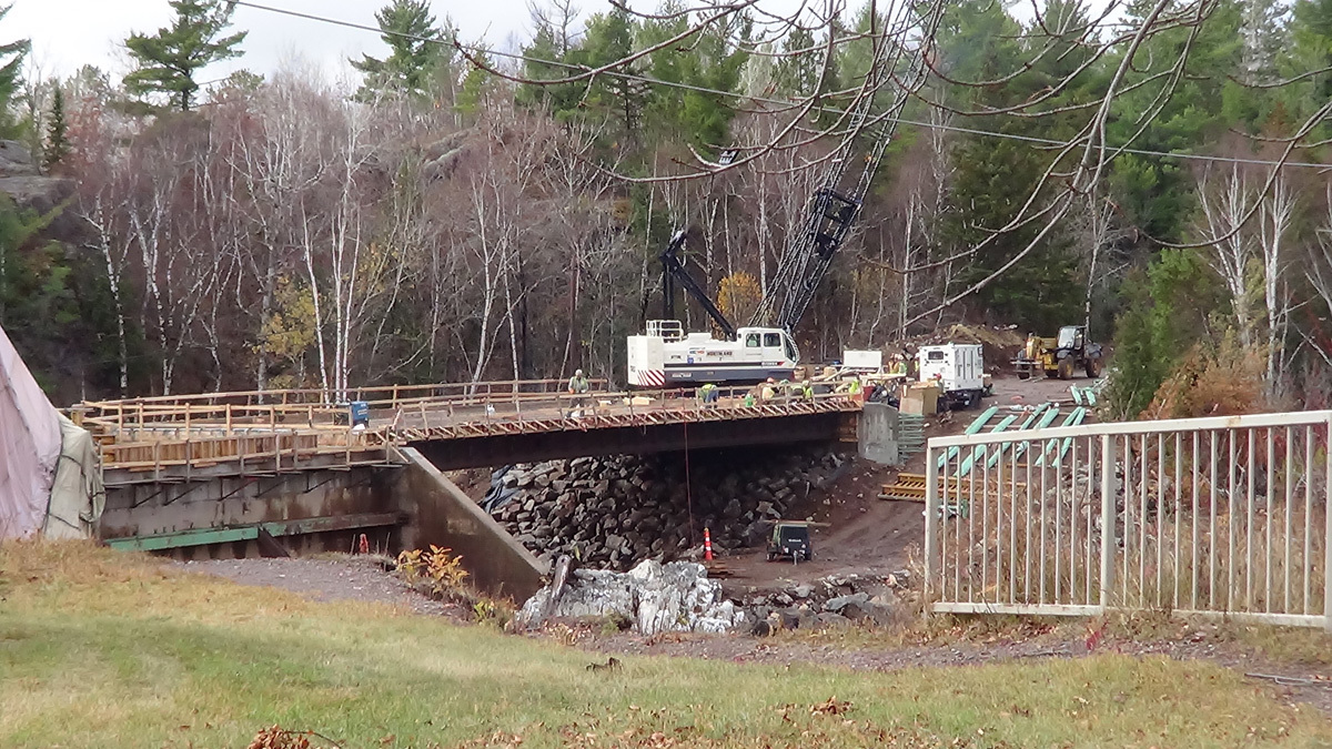 Construction crews rebuilding the Hwy 210 bridge