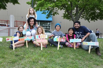 Kids and adults show their handmade signs