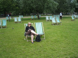 Woman relaxes in sling back chair in greenspace