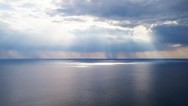 Photo of clouds and sun over water