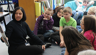 Mystery Reader, Commissioner Brenda Cassellius, reads to attentive students