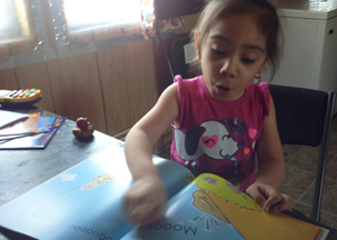 Young Head Start Participant Eagerly Reading Her New Book