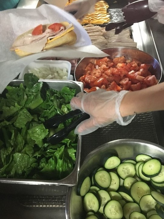 Single-use gloves, tongs and deli tissue prevent bare hand contact with ready-to-eat food