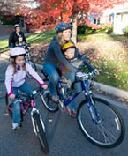 Family biking on city street in Edina