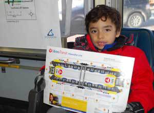 Photo of child with cardboard model LRT train