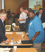 Contractors talking at construction mixer event.