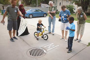 Group stenciling a stormdrain.