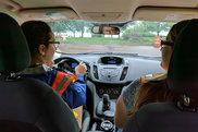 Interns driving in city vehicle.