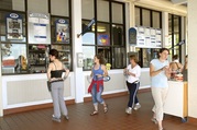 People stand underneath the awning at the Calhoun Refectory