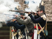 Living history re-enactors firing guns