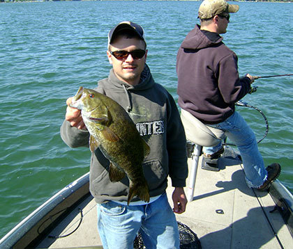 A man holding up his bass catch
