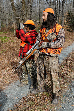 A man and a woman in hunting camo.