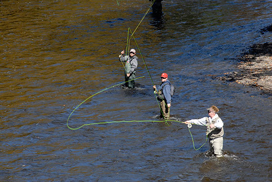 Men steelhead fishing in a river.