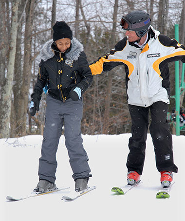A student with a ski instructor