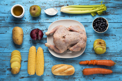 high-angle shot of a blue wooden table full of ingredients to prepare a stuffed turkey