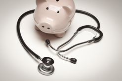 Piggy bank and stethoscope on a white background