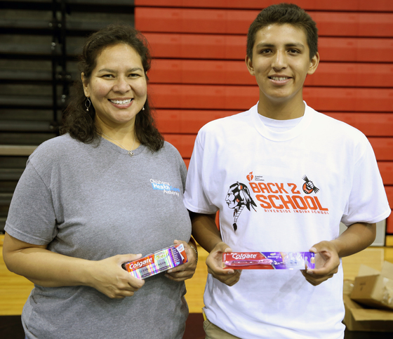 OHCA Tribal Government Tribal Relations Director Dana Miller gives Riverside student dental supplies.