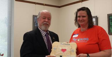 Causa member presenting senator with a plaque