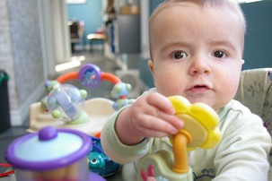 A baby plays with toys. 