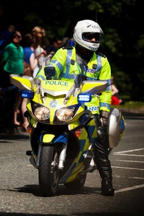 A police officer on a motor cycle.