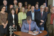 Mayor Dean signs the Executive Order creating the Mayor's Office of New Americans