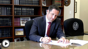 Photo of Texas Comptroller Glenn Hegar certifying the Texas budget