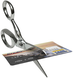 Photo of a credit card being cut in half.