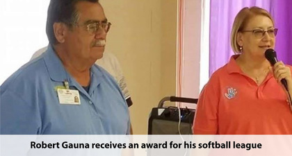 Photo of Robert Gauna receiving an award