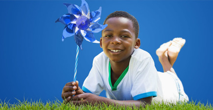 Photo of boy with blue pinwheel