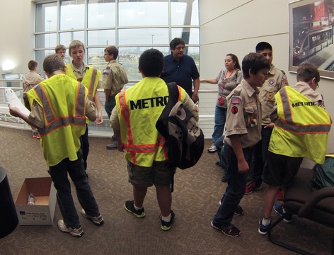 Scouts suit up in safety vests before they begin touring METRO's Rail Operations Center
