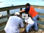 father and two children fishing
