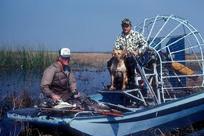 2 duck hunters in air boat