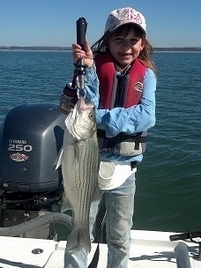 on dock, smiling little girl with really big fish