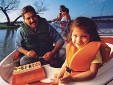 family in boat with life vests