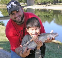 Boy with dad and catfish.