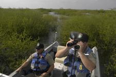2 game wardens, boat
