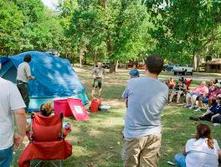park ranger teaching adults,children about tents 