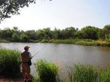 angler bank fishing, quiet pond
