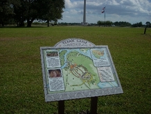 educational panel in field, Monument in background