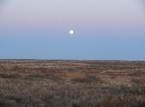 moonrise over flat prairie