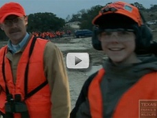 smiling youth in orange safety vest