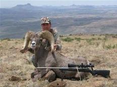 hunter with trophy big horn sheep, West Texas sky
