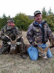 two mean each with a whitetail buck trophy